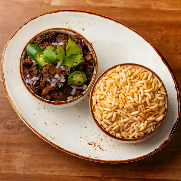 Indian dish with dark meat, red onions, cilantro, and jalapeños, served with puffed rice.